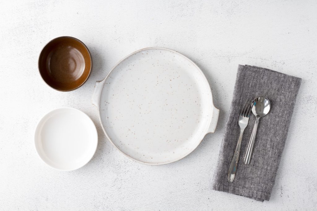 In this article, Cole Shiflet answers the question, "What does the Bible say about giving?" This picture features an empty white plate.