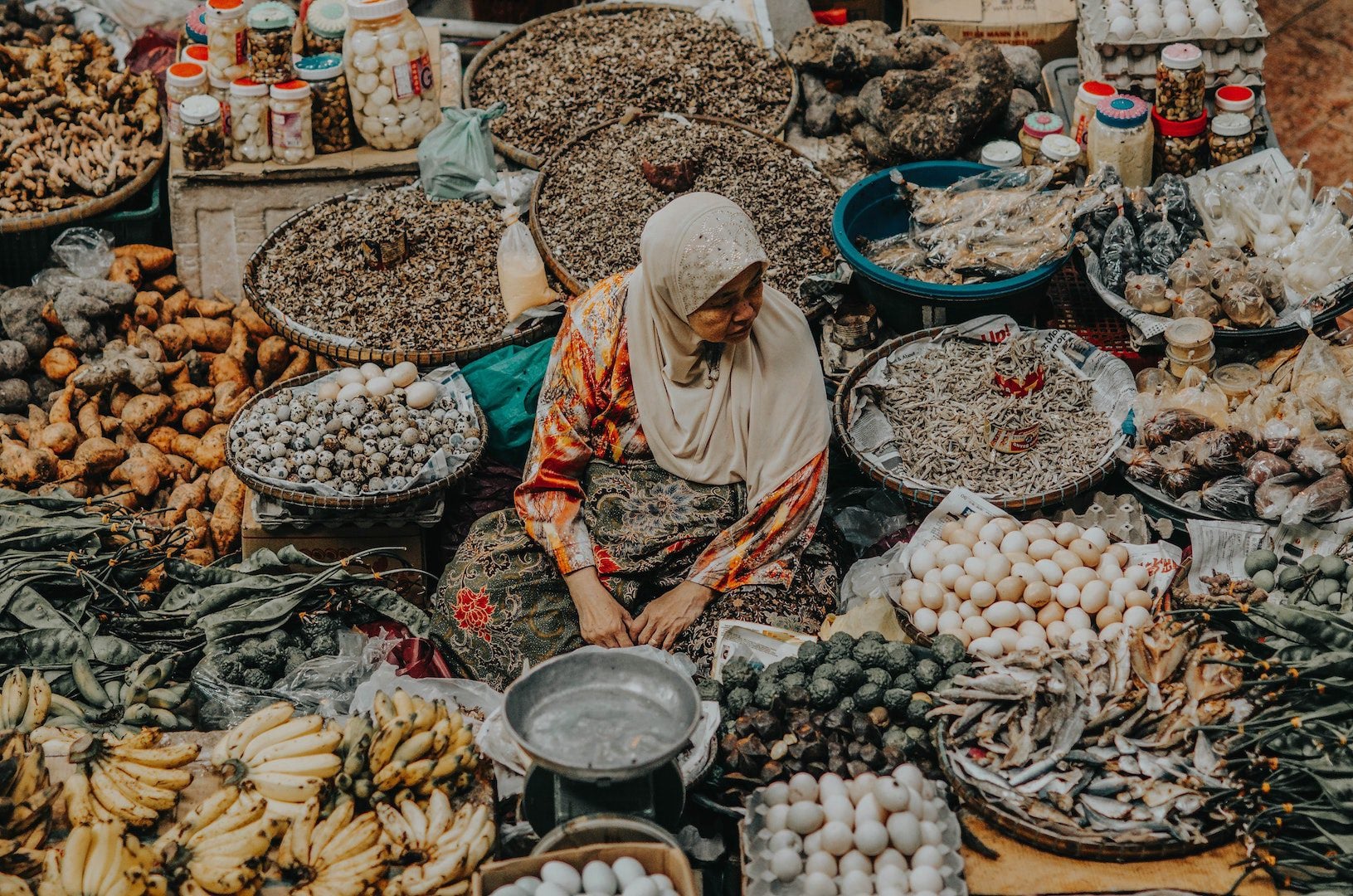 A woman selling fruits at a market.