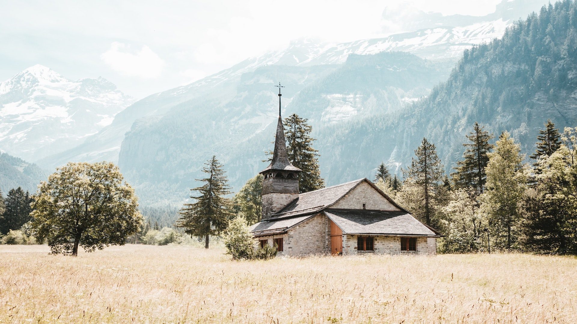 A stone church in a field.