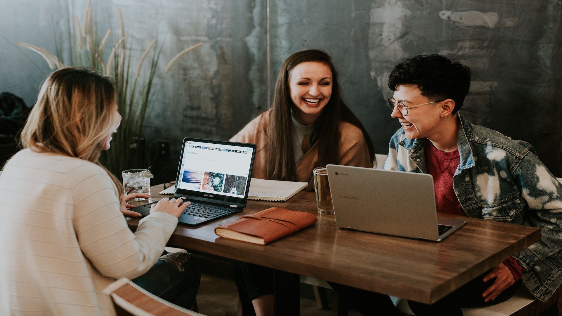 Three people sitting at a table.