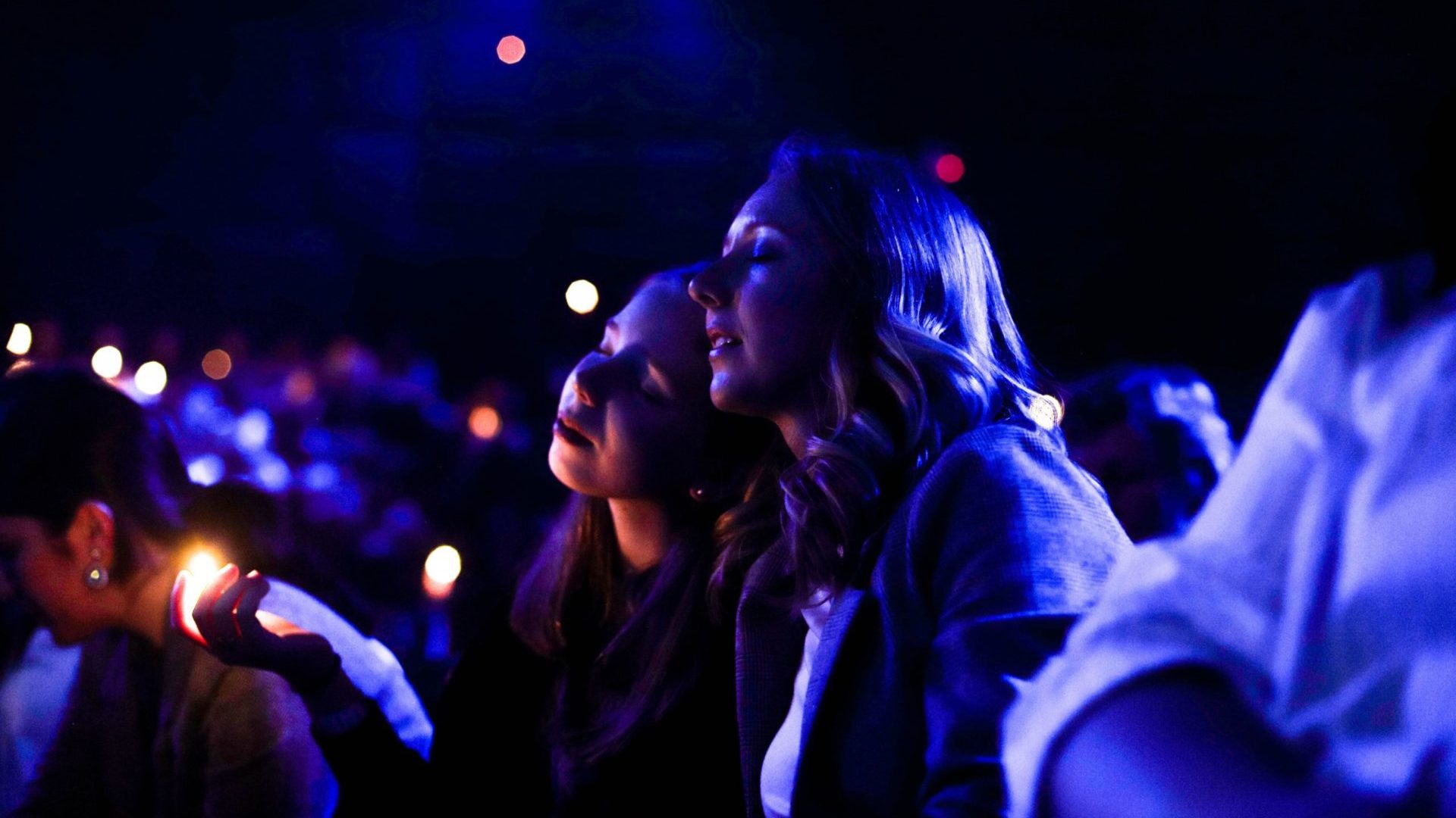 Two girls praying together with their eyes closed