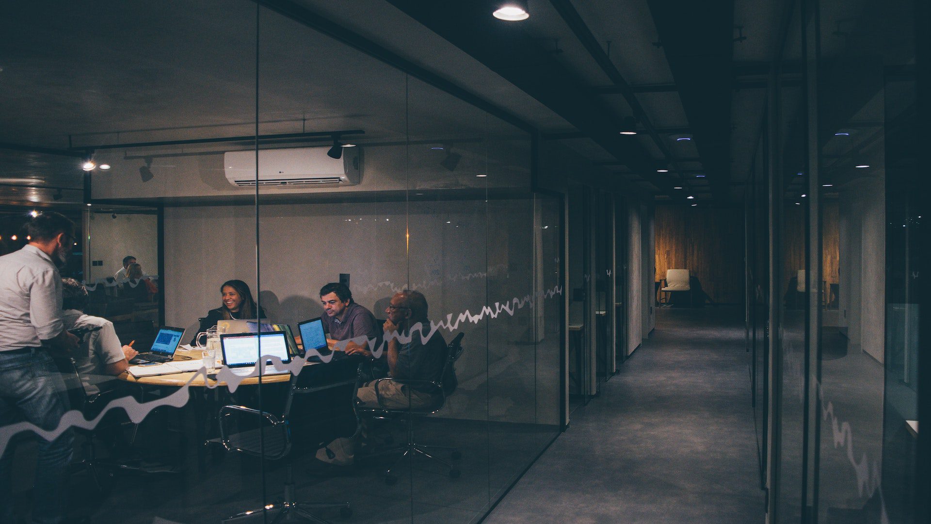Workers in a conference room during a business meeting.