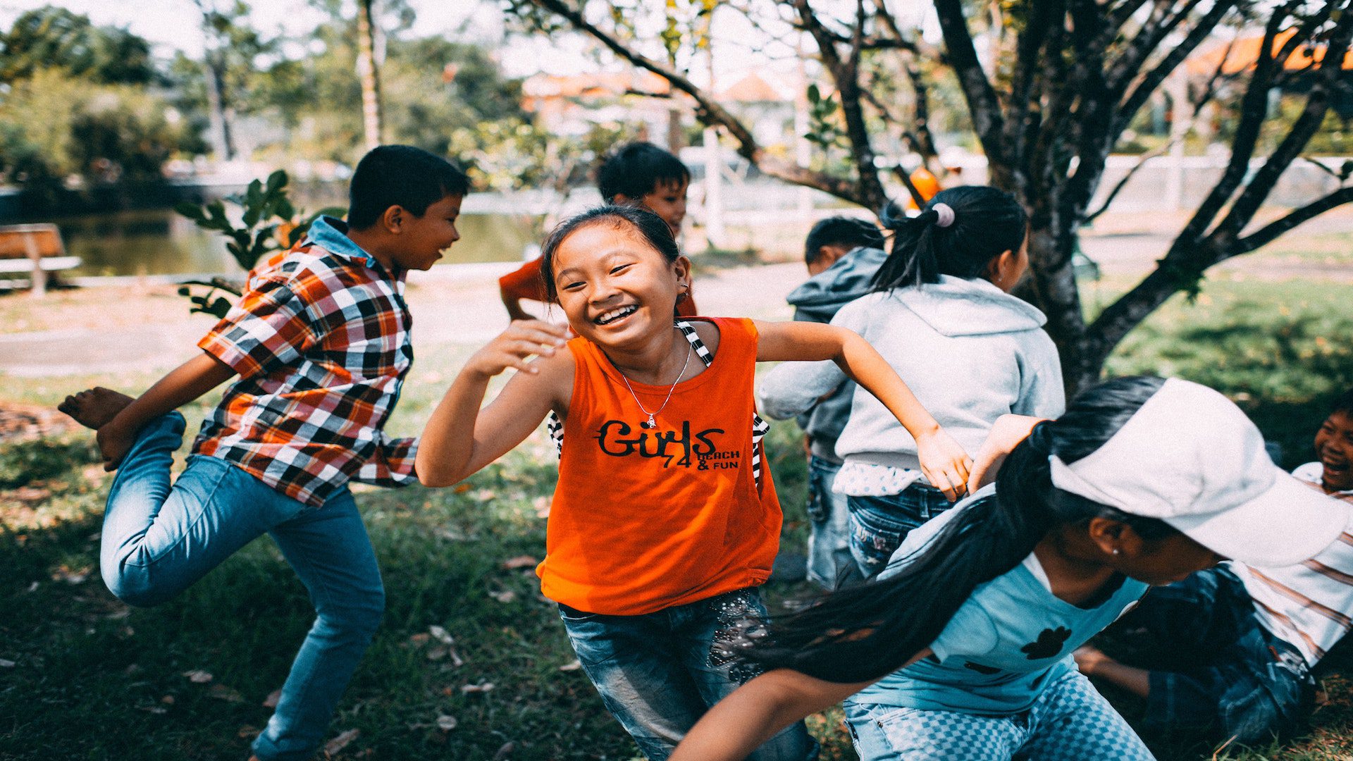 A group of kids running outside.
