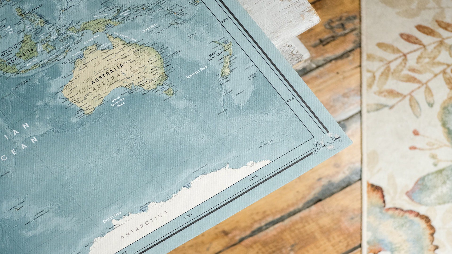 A world map on a wooden table.