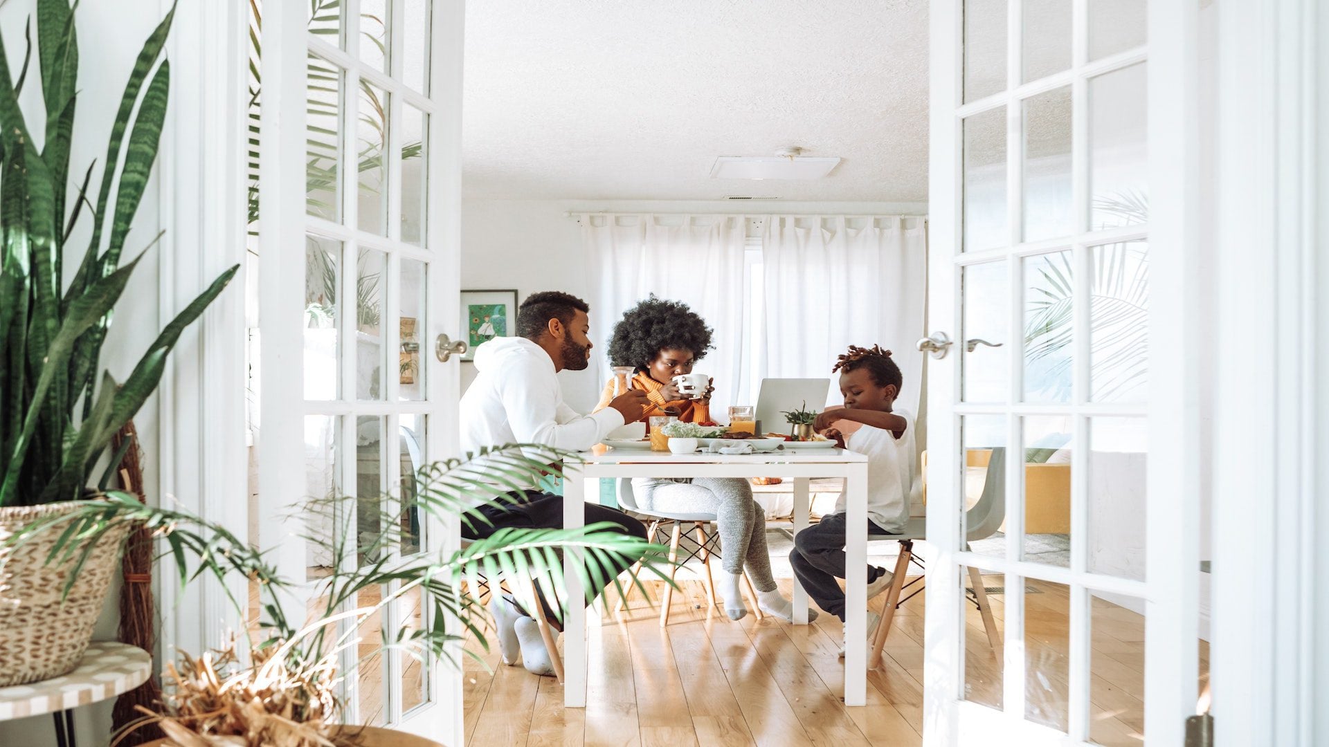 A family eating breakfast at a dining table together.