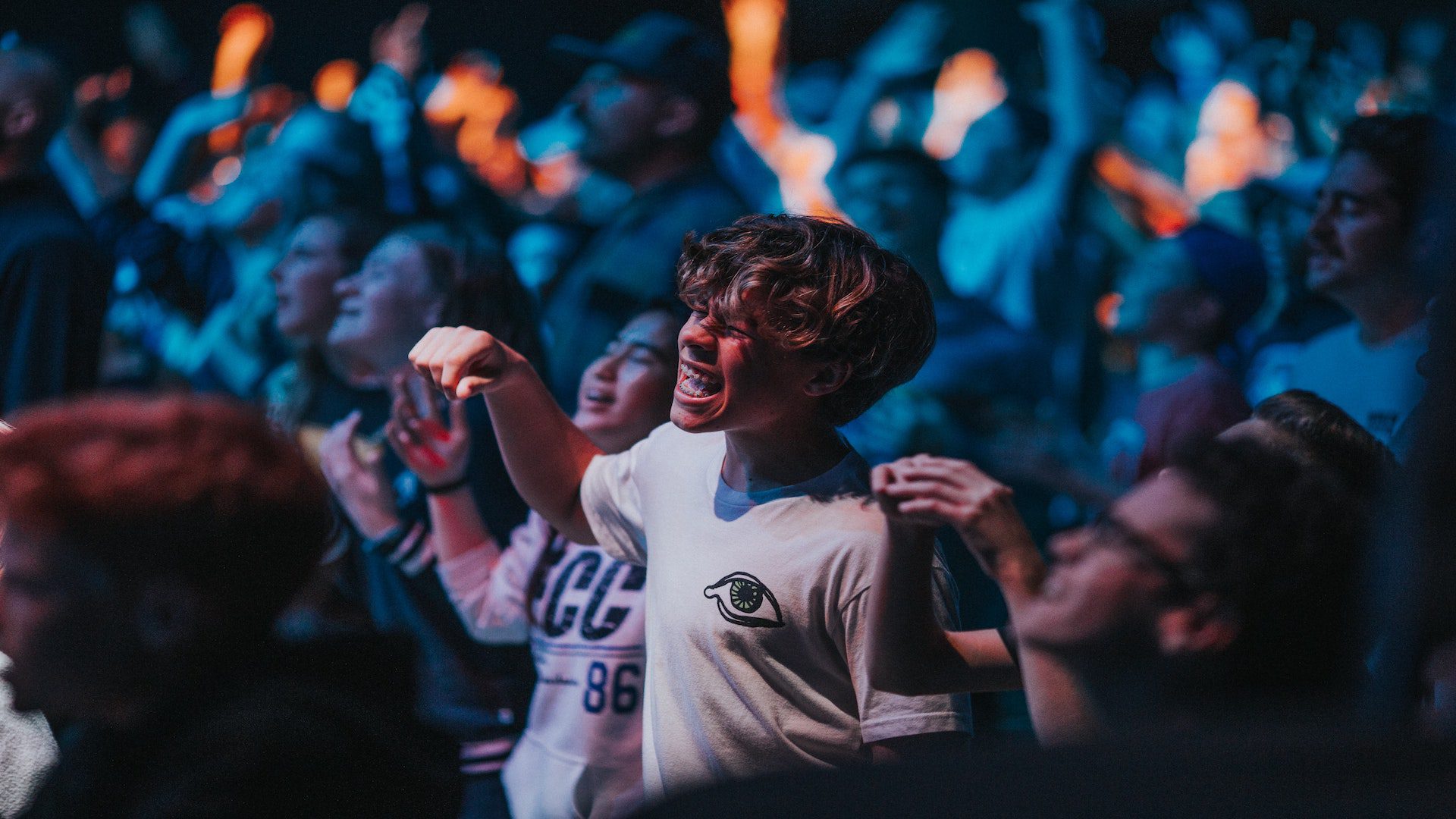 Teenagers worshiping during a church service.