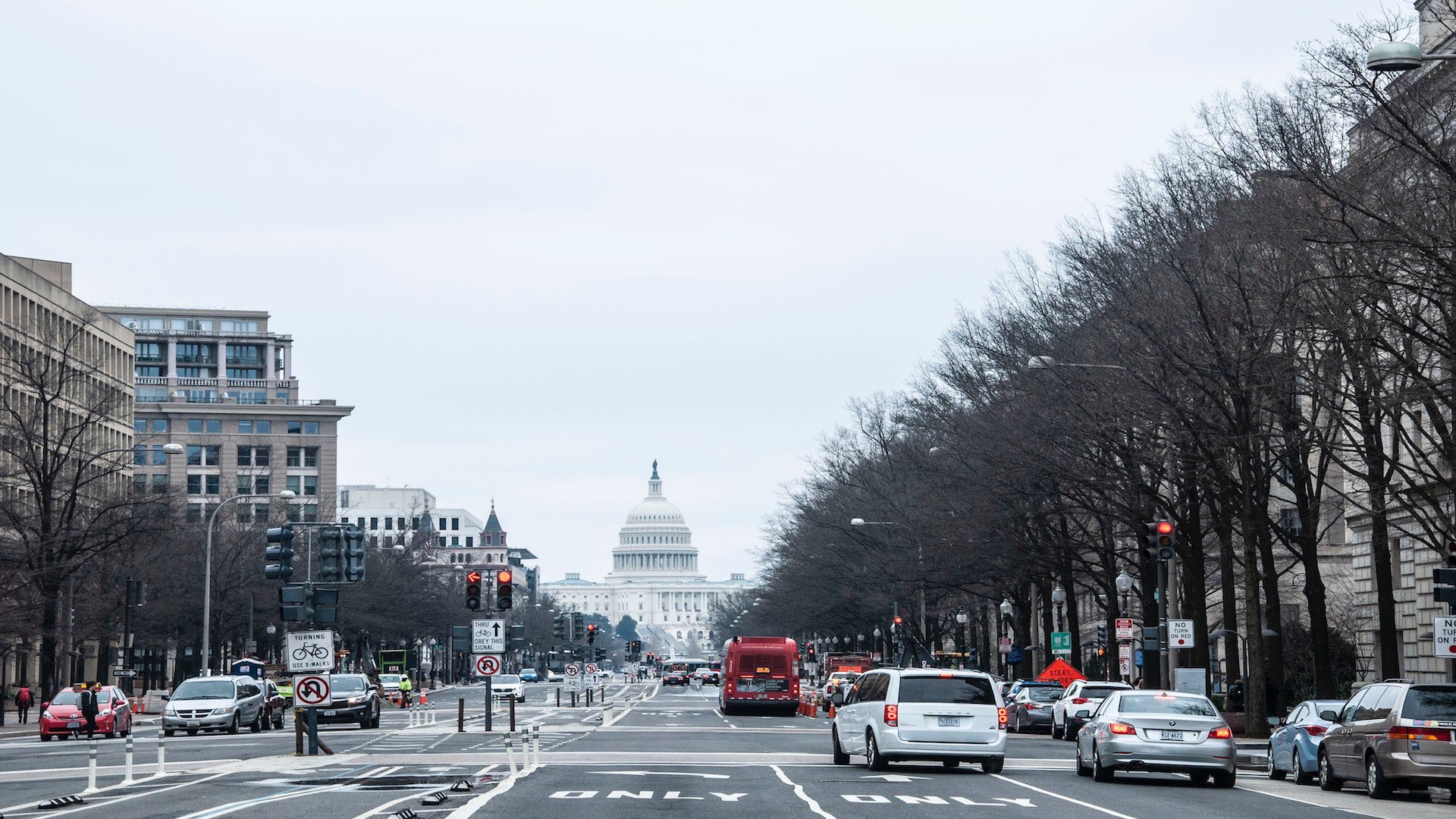 Cars driving on a road near the Capitol building in Washington DC.