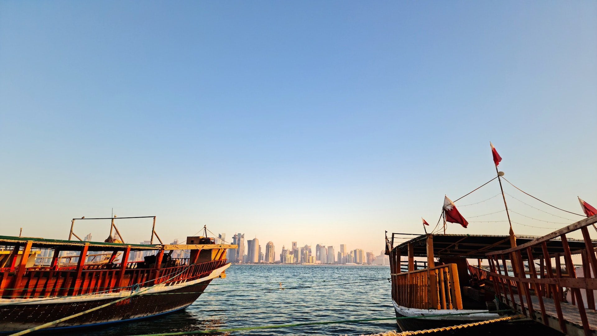 Boats in the water with a city skyline in Qatar.