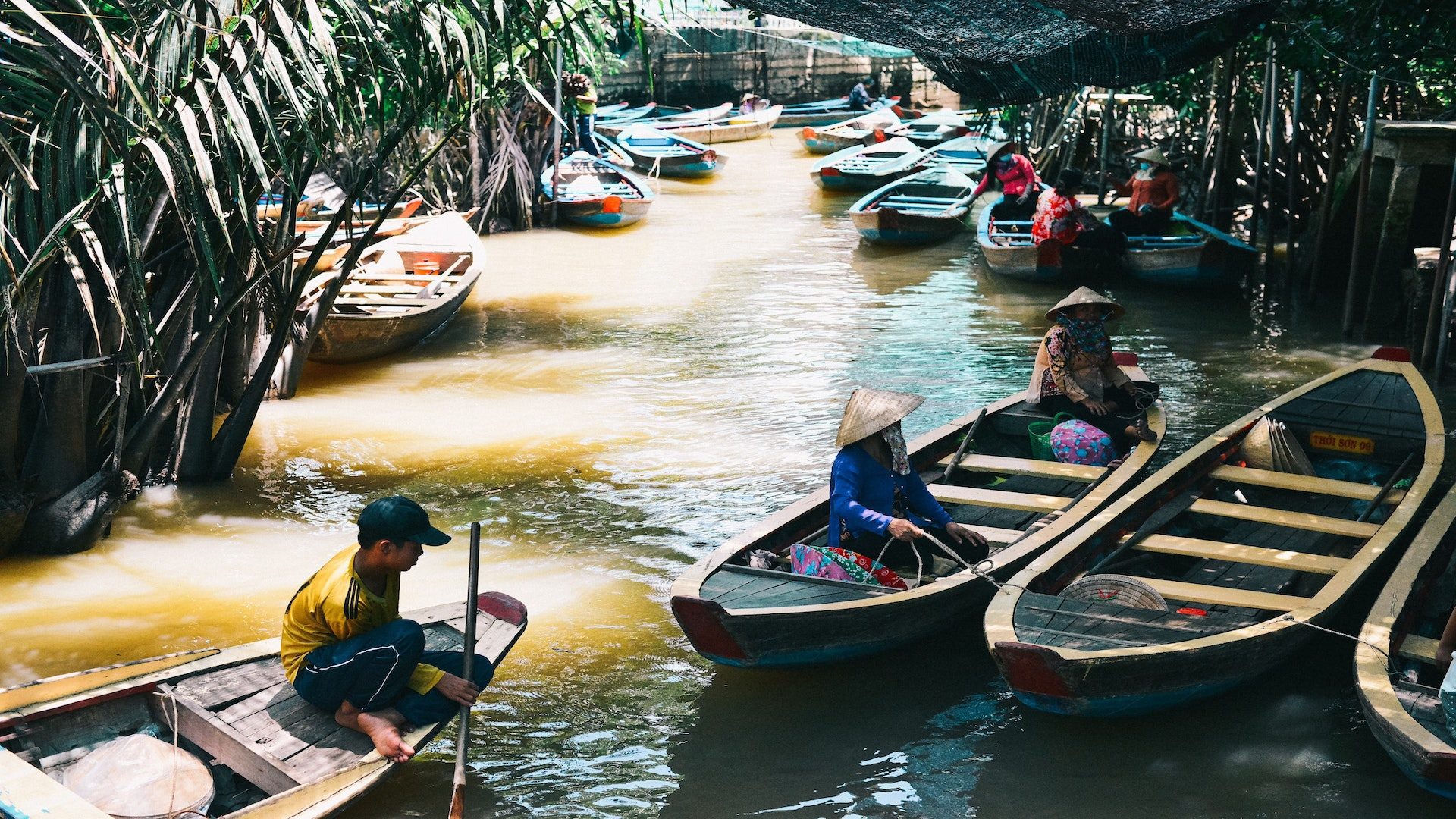 People in boats on a river in Vietnam.