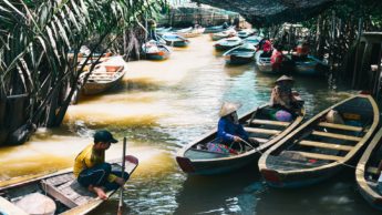 People in boats on a river in Vietnam.