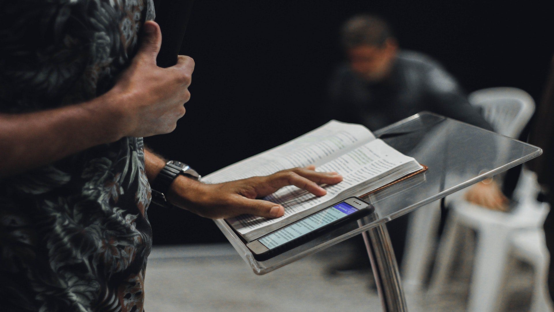 Pastor's Bible and phone on podium during sermon.