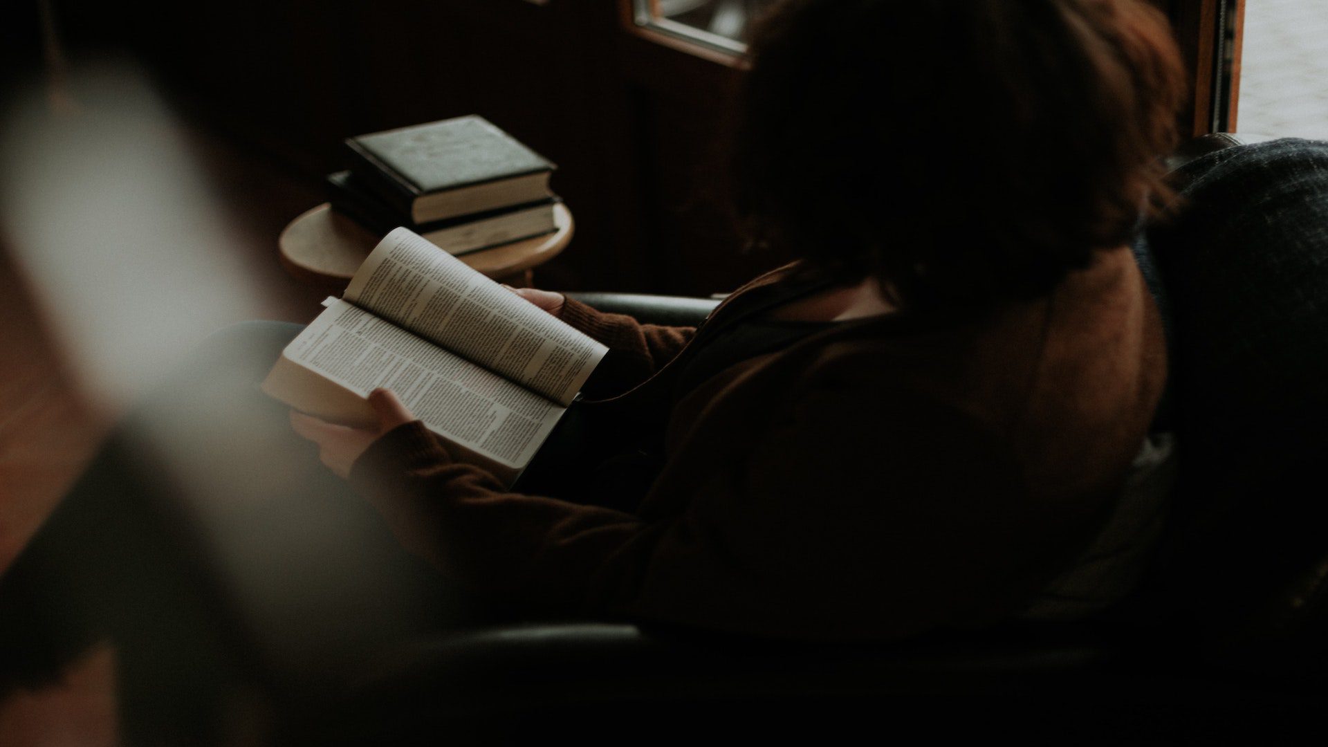 Woman sitting and reading the Bible.