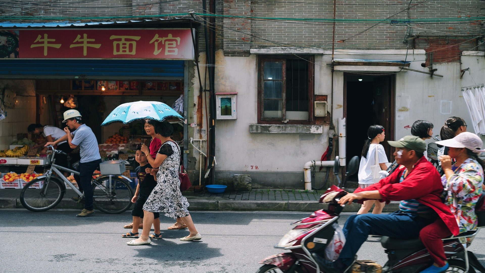 People in China walking outside on a city street.