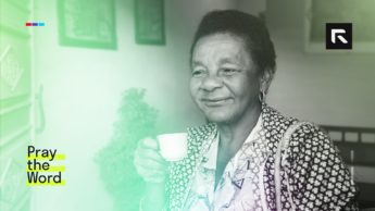 An elderly Cuban woman sits with a cup of coffee/