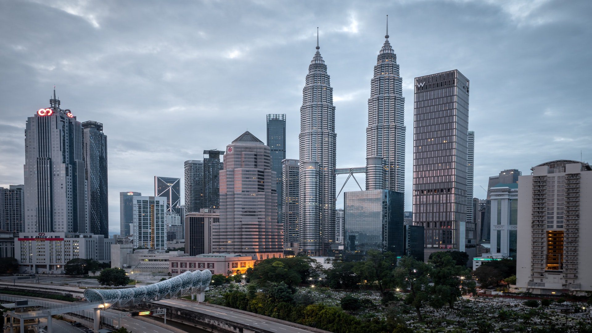Skyscrapers in a Malaysian city on a cloudy day.