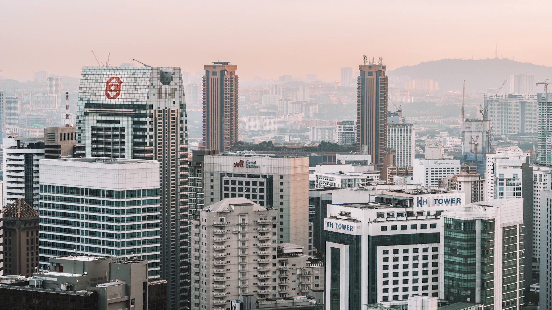 White and gray skyscrapers in Malaysia on a foggy day.