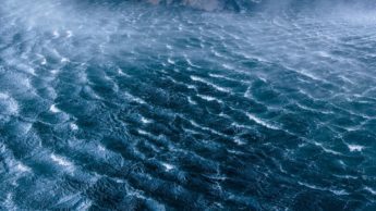 Aerial view of blue waves in an ocean.