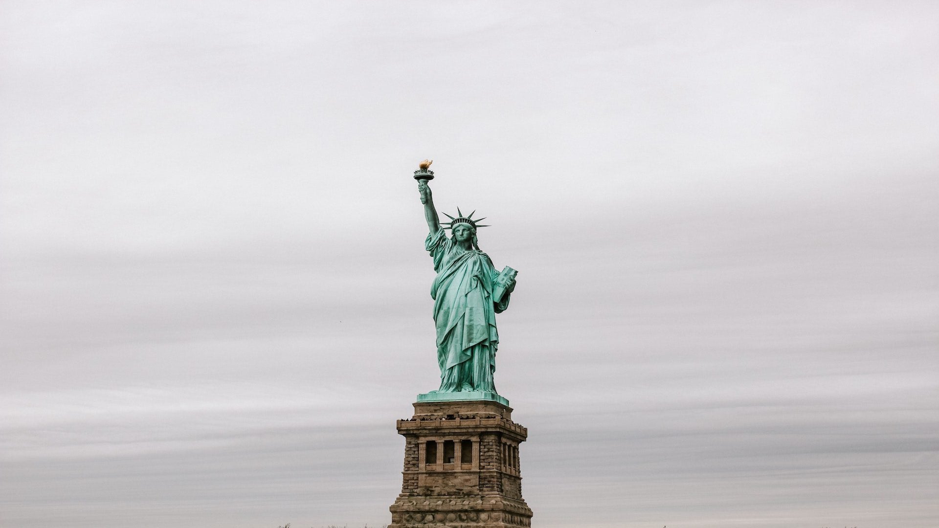 Statue of Liberty in front of a gray sky.