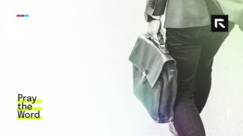 A man walks to work with a bag.