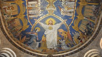 A beautiful painting of Jesus on the inside of a dome in a church.
