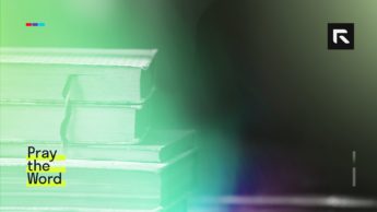 A stack of books sit on the table.