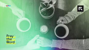 A married couple sits at a table drinking coffee.
