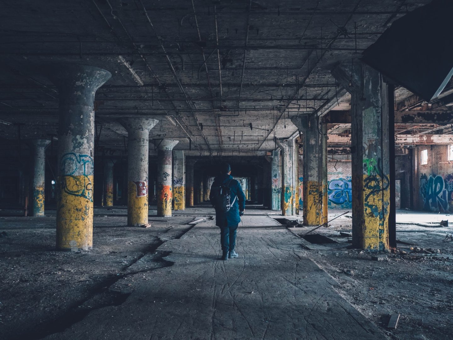 A man walks through an abandoned building.