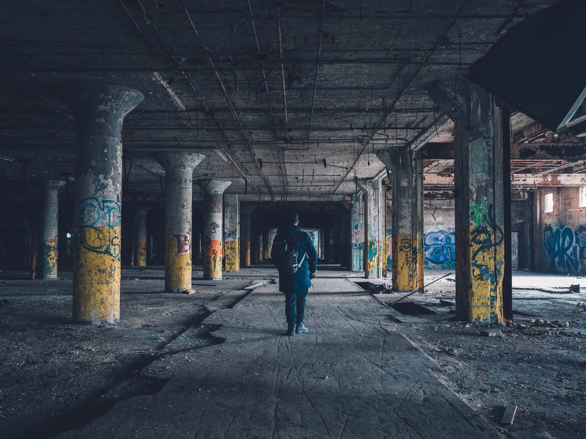 A man walks through an abandoned building.
