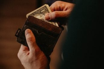 A man pulls money out of his wallet.