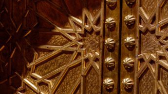 Bronze door with star shaped carvings.