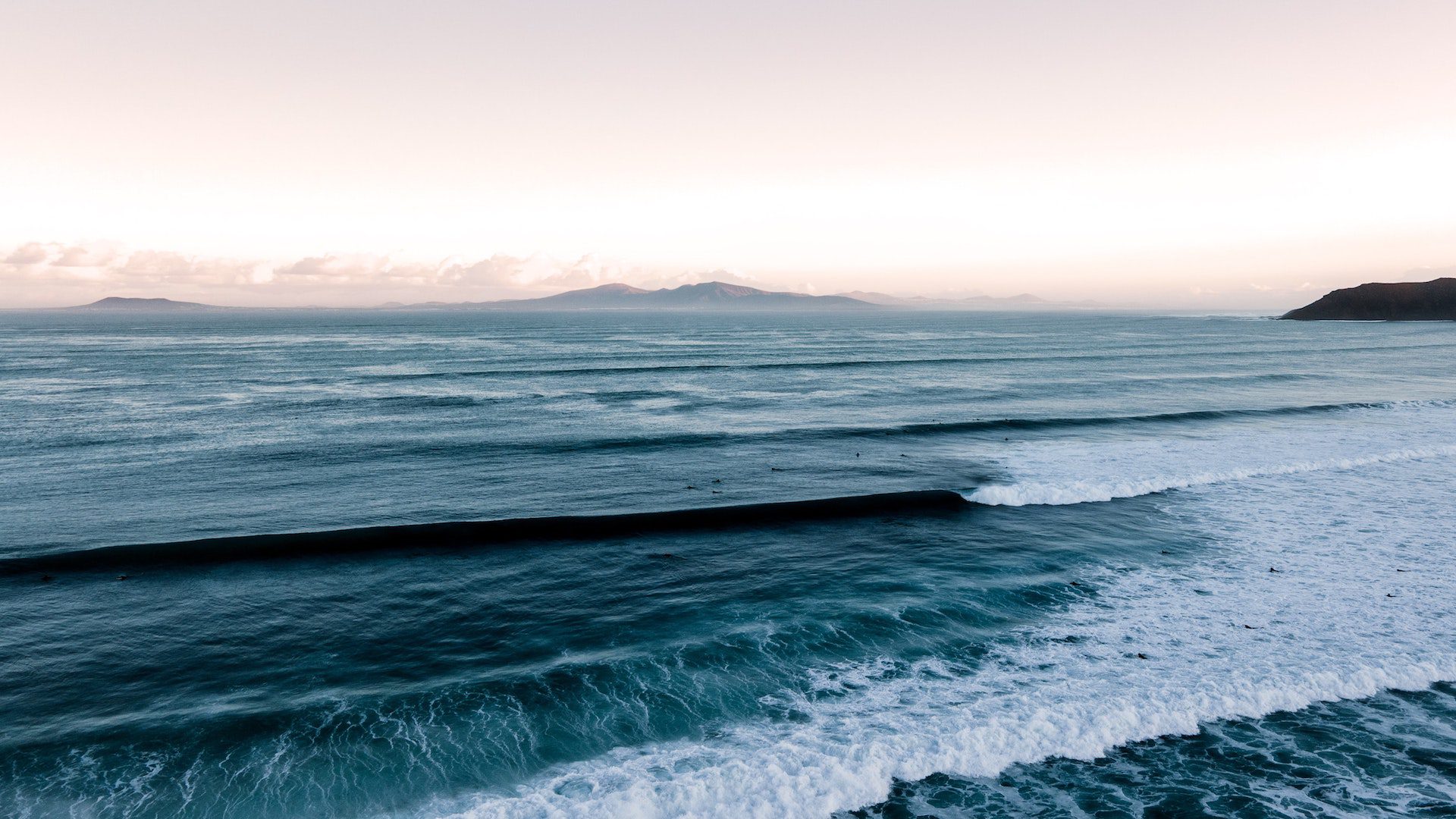 Aerial view of ocean waves crashing.