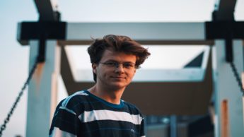 Man in a striped shirt and glasses.