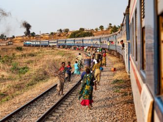 People walk along a railway.