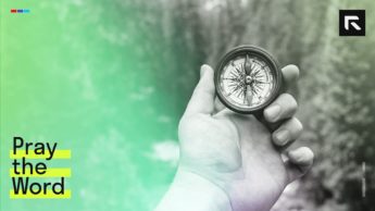 Person using compass to find the right way