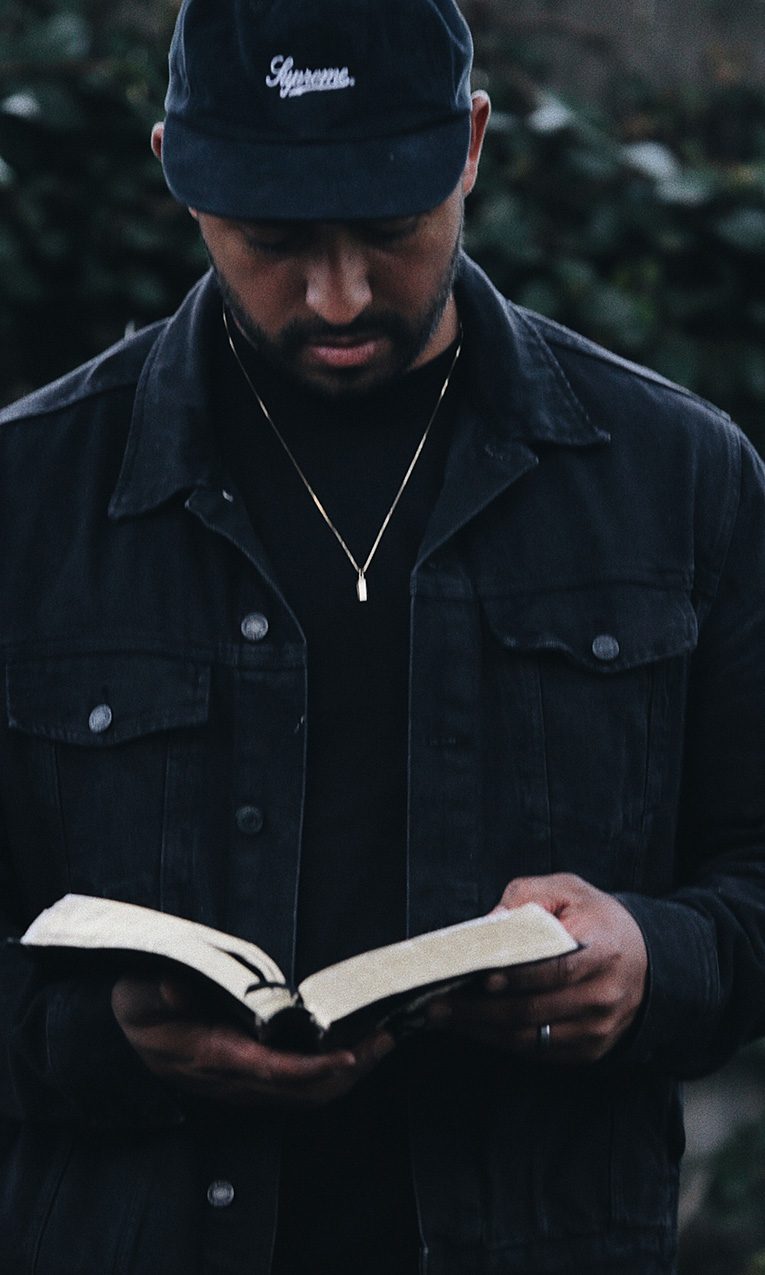 Man in black jacket holding the Bible