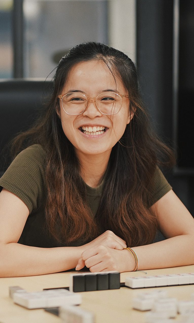 asian female students playing board games and laughing together