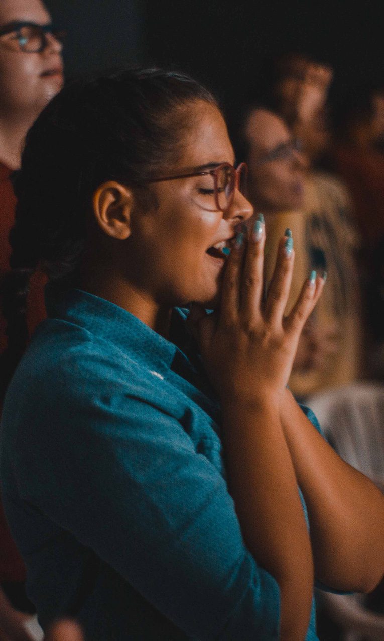 female college student praying in church