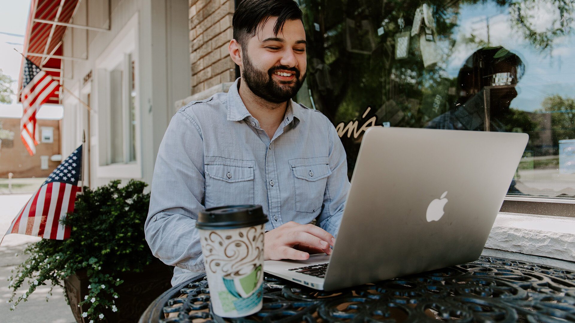 man using laptop in a cafe