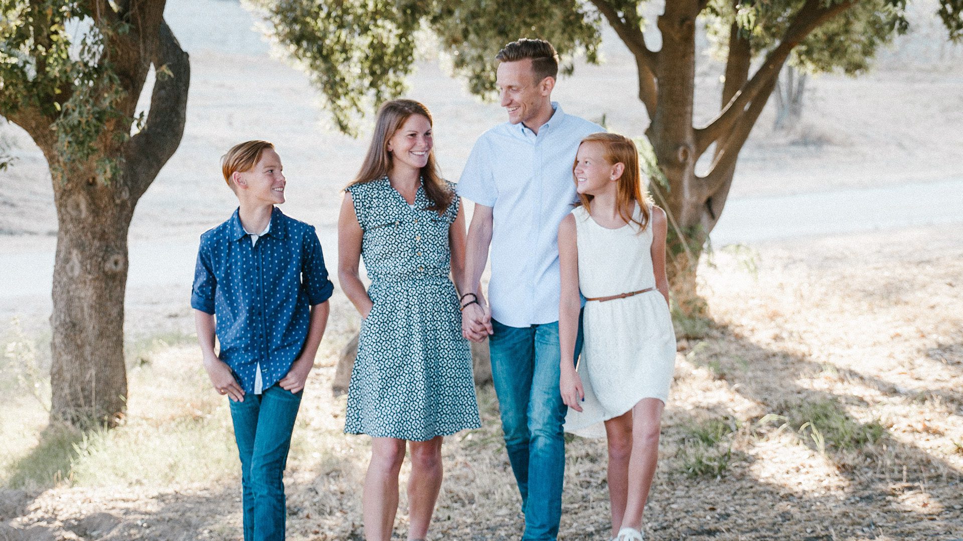 a family standing in front of trees
