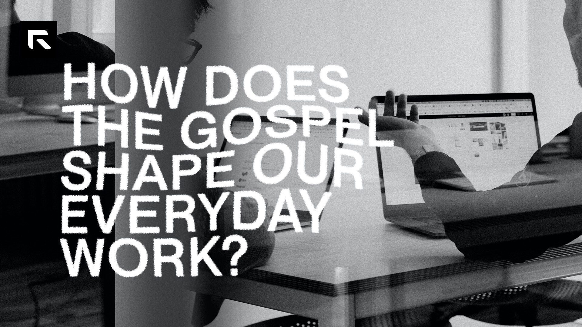 A black and white picture of two mean sitting at the corner of a table facing their laptops with the text 'How Does The Gospel Shape Our Everyday Work?"