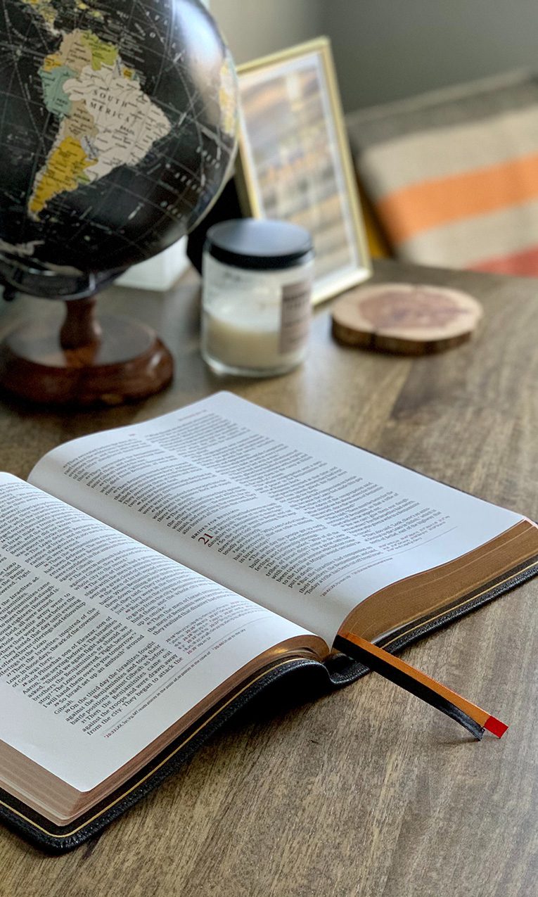 open Bible on brown wooden table