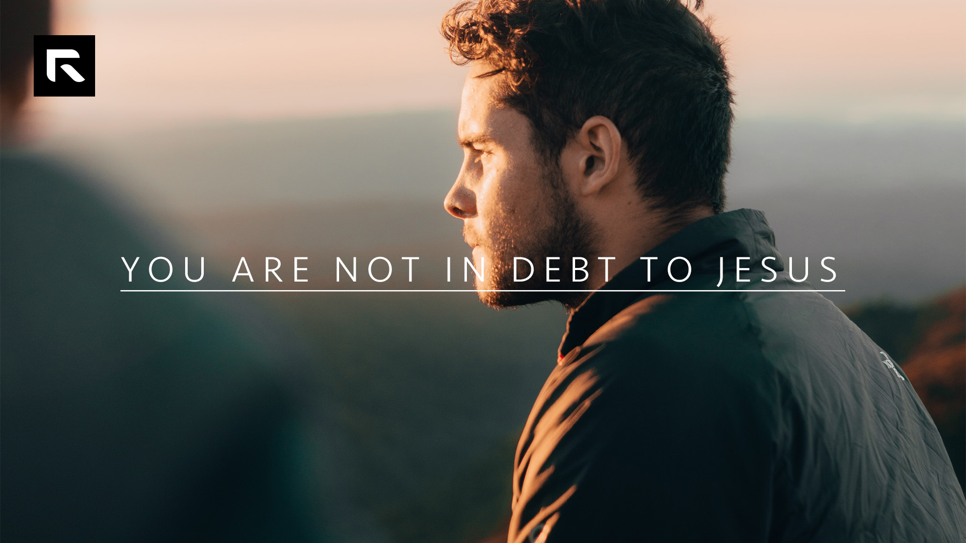 A picture of a man staring off to the side with the sun shinning on his face and the text "You Are Not In Debt To Jesus"