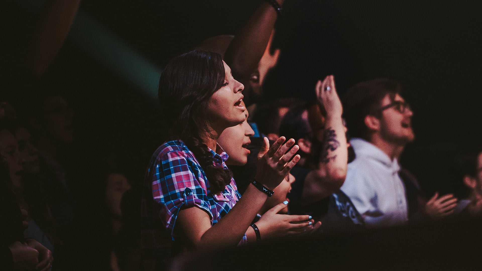 woman singing during worship in a church service