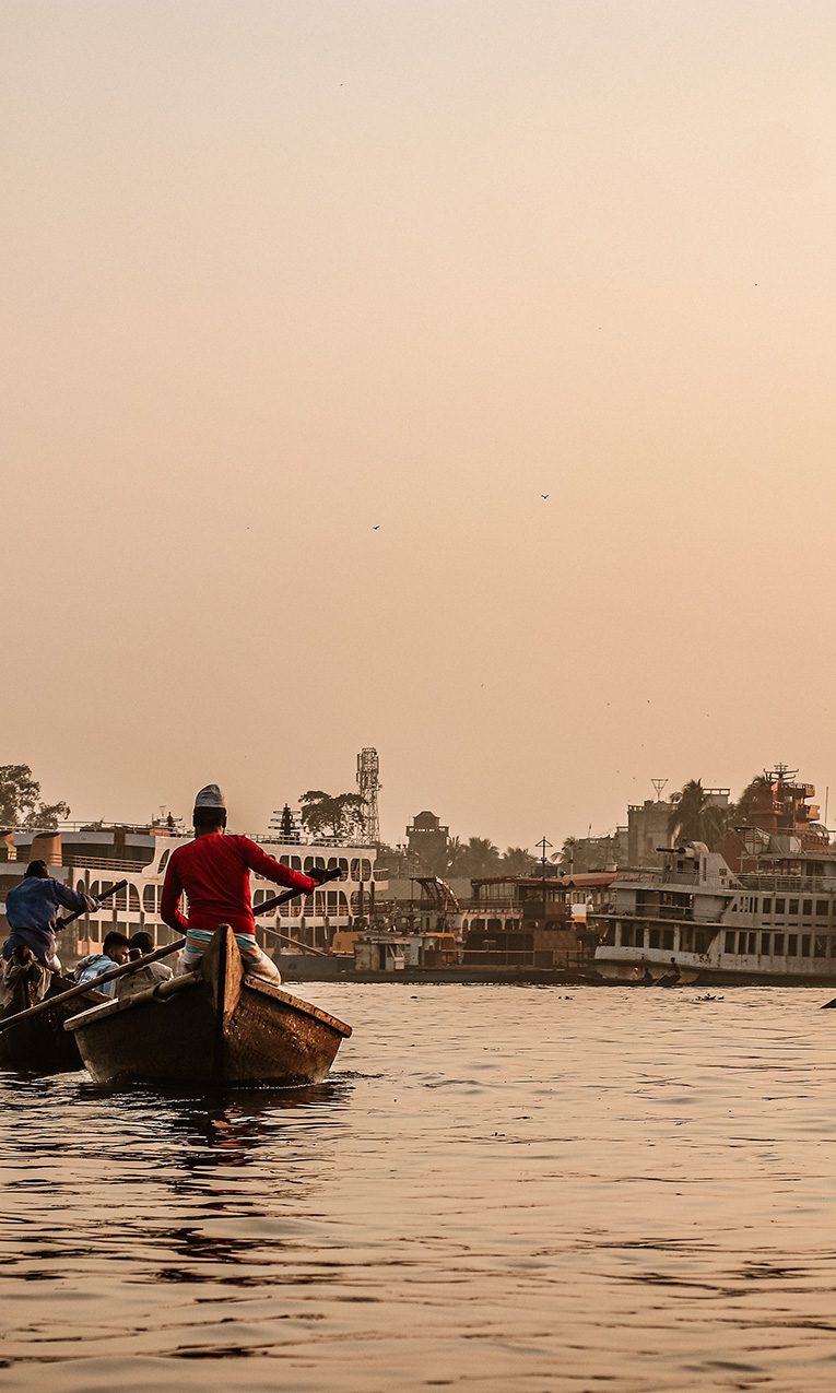 man in red shirt riding on boat during daytime