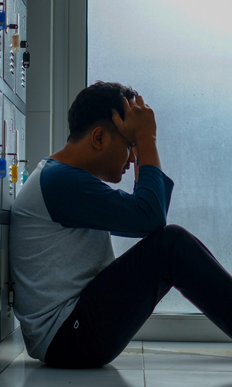 a man sitting on the floor looking discouraged