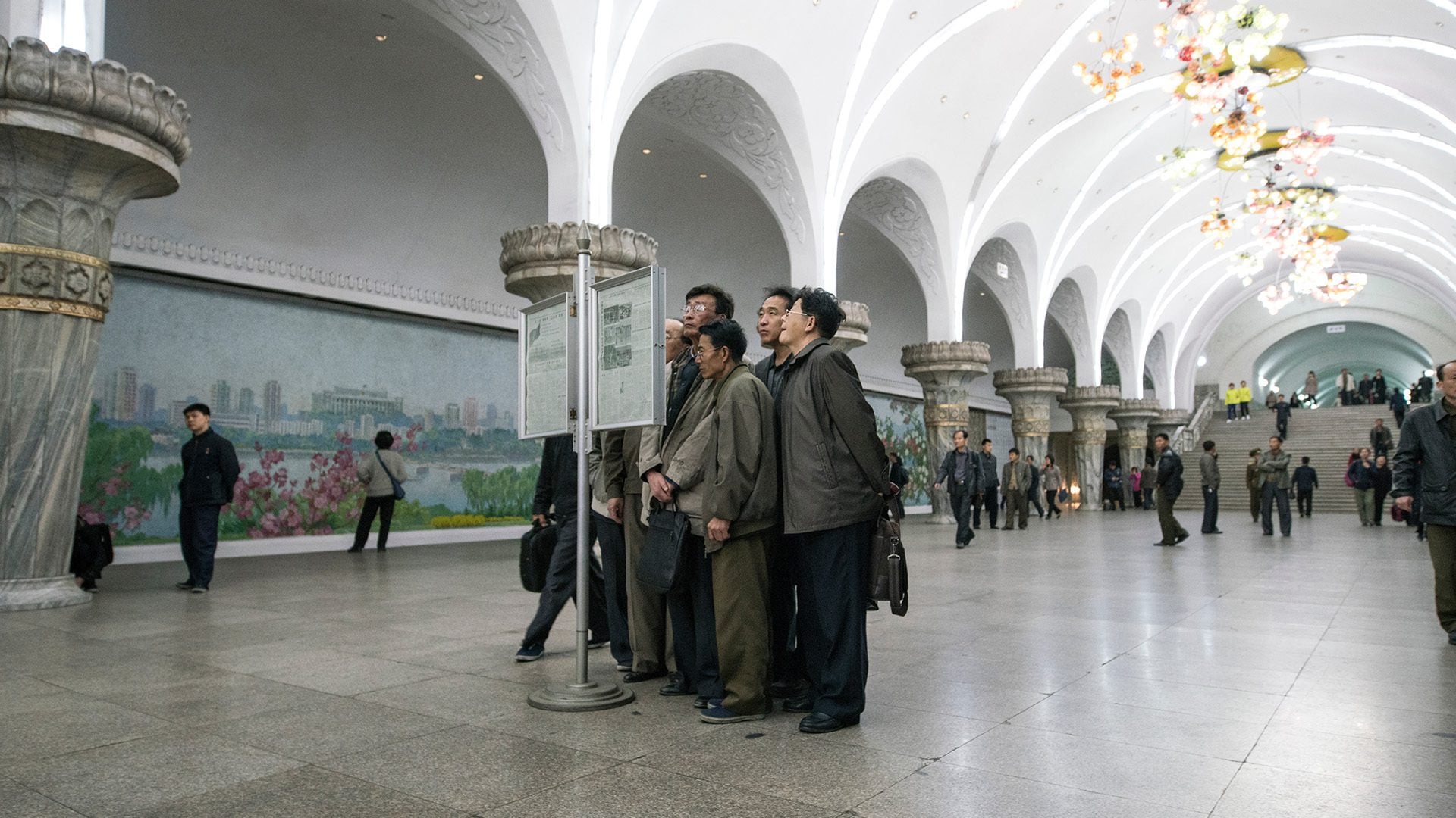 Group of men reading a signage
