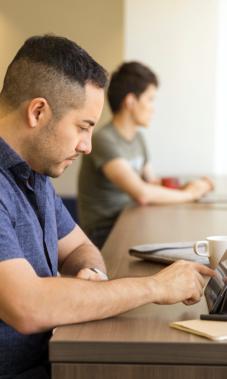photo of two men studying on electronic devices