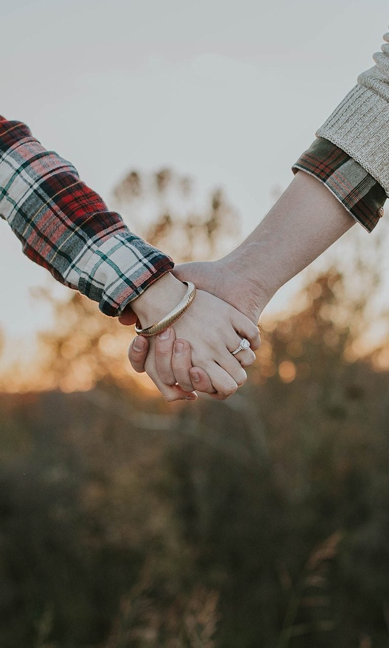 husband and wife holding hands lovingly