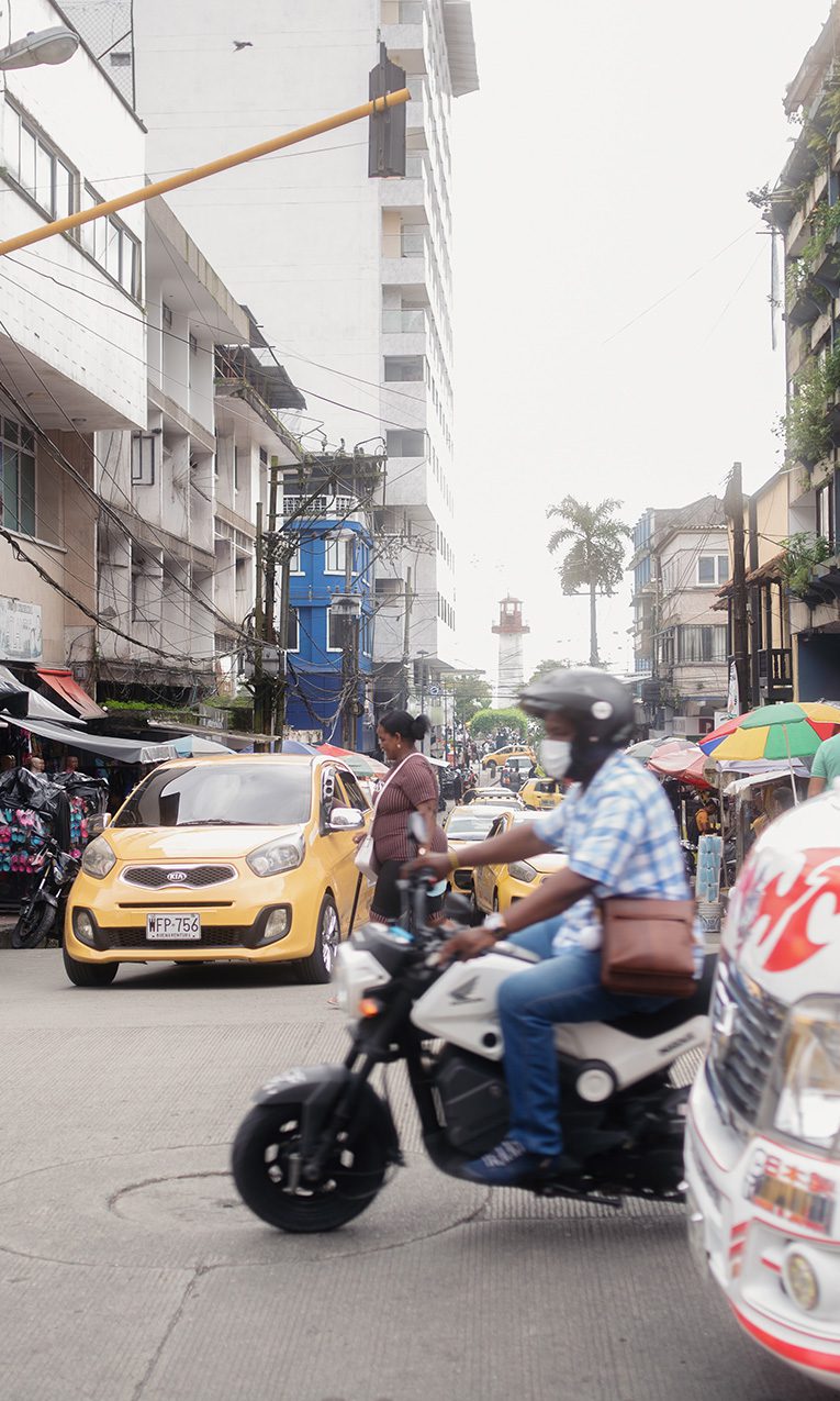 a person riding a motorcycle in a busy street
