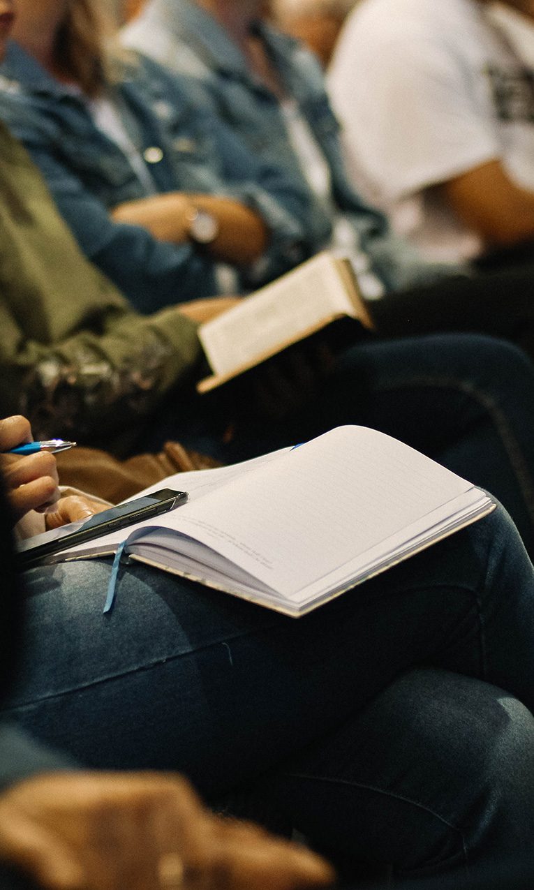 people sitting down and taking notes at church